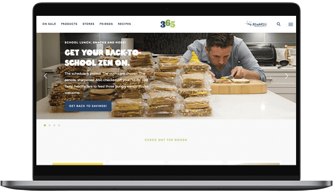 A person preparing healthy school lunches in a kitchen, surrounded by neatly stacked packed meals. The website promotes back-to-school meal prep solutions.