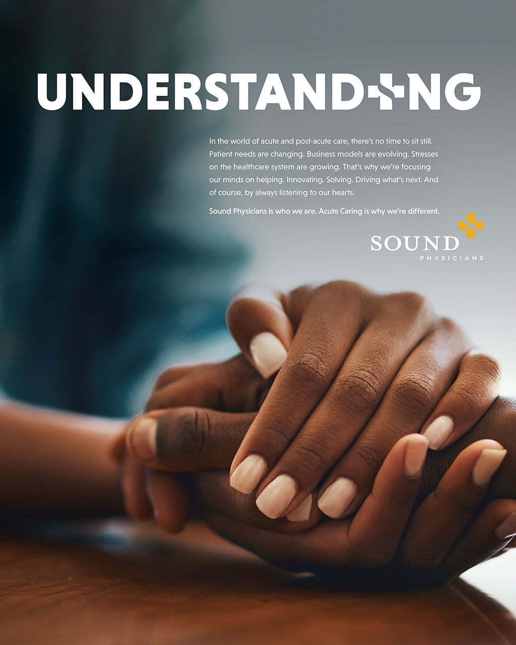 Two hands clasped together on a wooden surface, symbolizing support and care in healthcare. The image reflects the commitment of Sound Physicians to understanding patient needs and adapting to changes in the healthcare landscape.