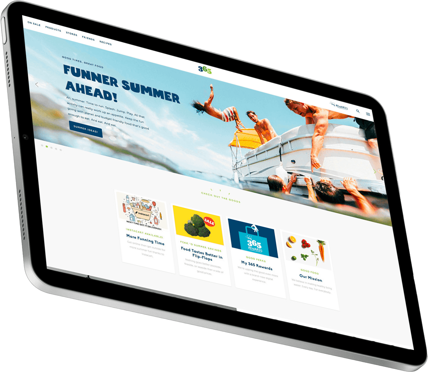 Tablet displaying a vibrant summer-themed website featuring people enjoying water activities, with sections highlighting fun summer products and promotions.