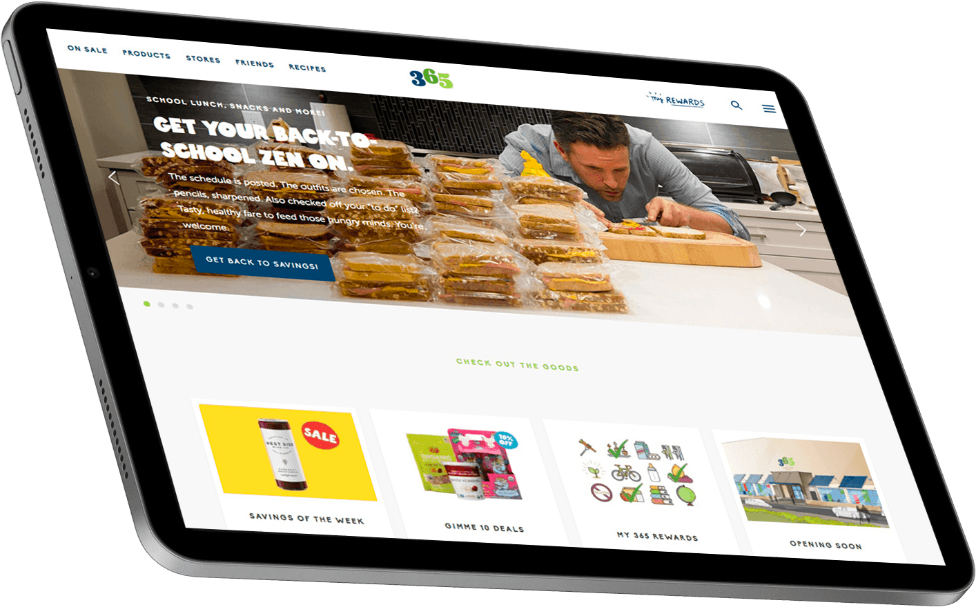 A tablet displaying a website homepage featuring a man working with packaged food products, promoting easy meal preparation and healthy eating options. The site includes sections for featured products and a call to action for visitors to explore more.