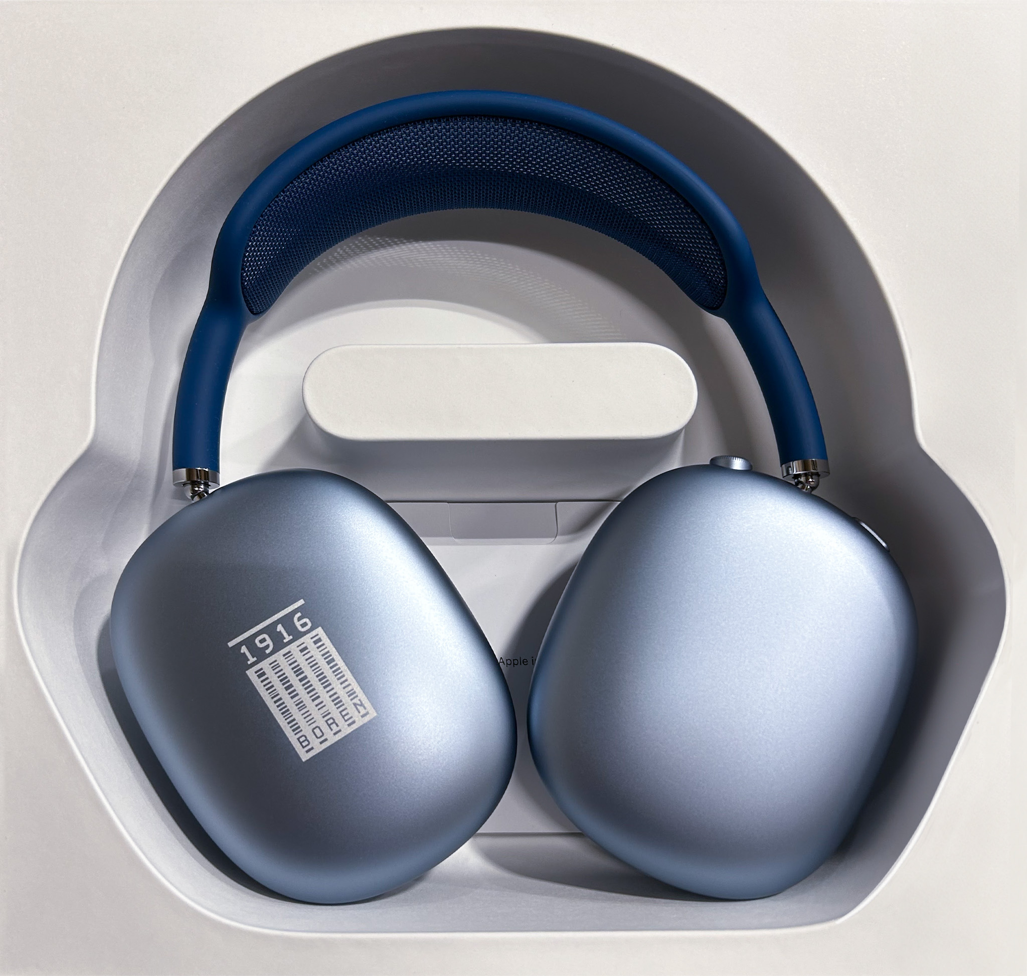 Blue over-ear headphones displayed in their packaging, featuring a sleek design and cushioned ear cups for comfort. Ideal for immersive audio experiences and noise cancellation.