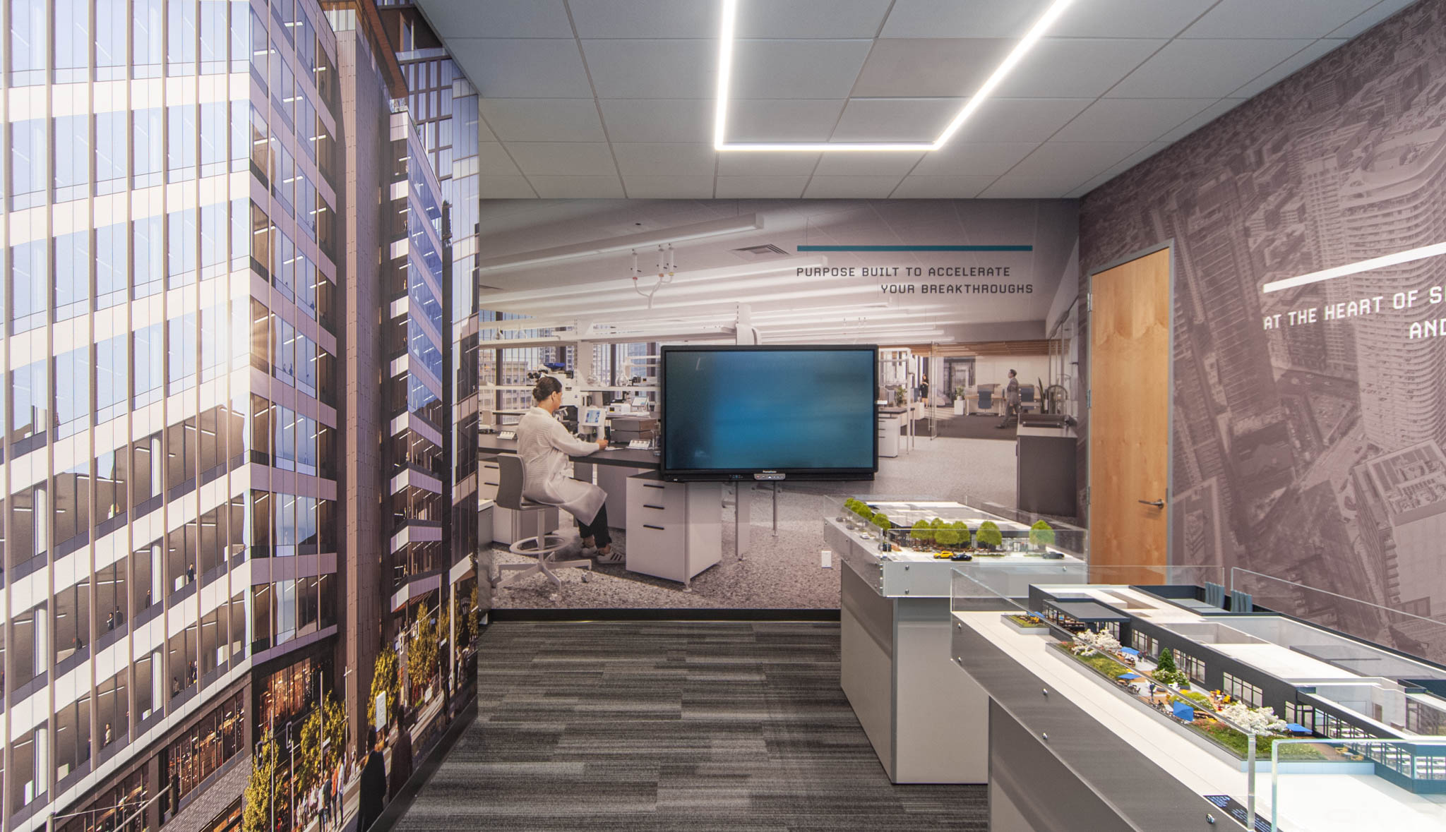 Modern office interior featuring a large wall-mounted screen, sleek furniture, and architectural visuals, designed for collaborative work and presentations.