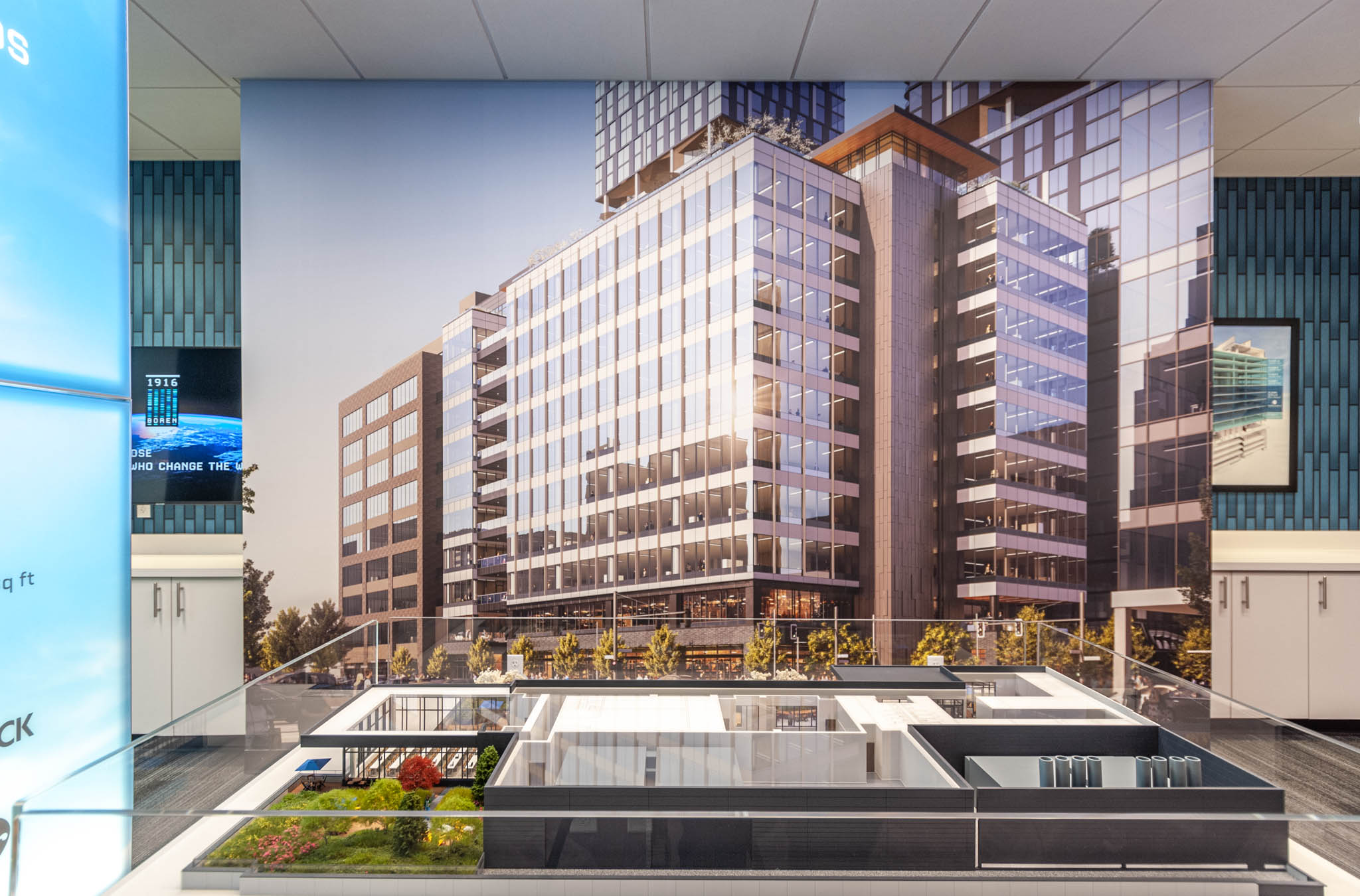 Modern office building with large glass windows and a landscaped courtyard, showcasing contemporary architectural design.