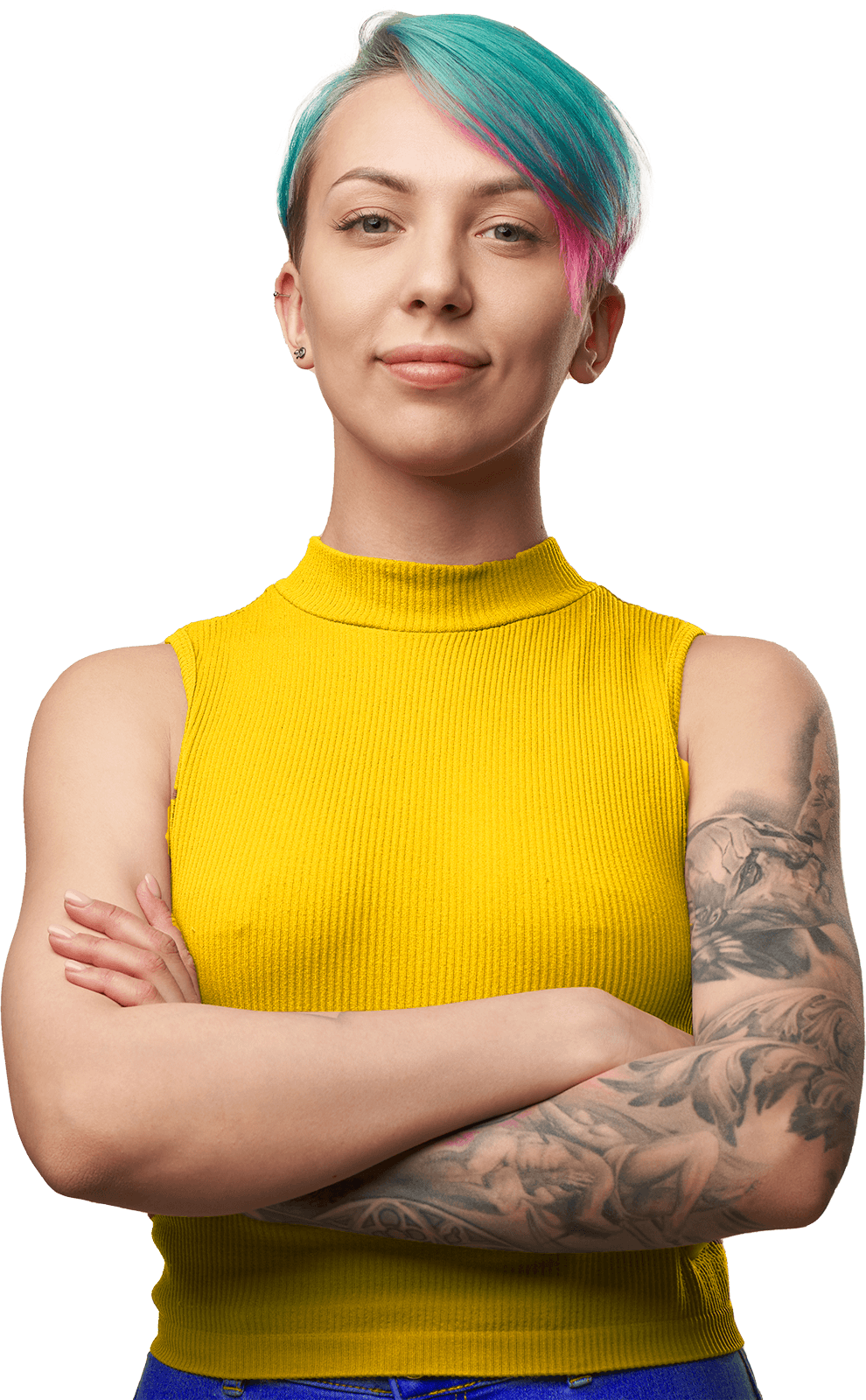 Confident young woman with short, colorful hair and tattoos, wearing a yellow sleeveless top, standing with arms crossed against a plain background.