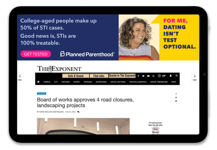 Tablet displaying a webpage from The Exponent featuring an article about road closures and landscaping projects, alongside a Planned Parenthood advertisement emphasizing the importance of STI testing for college-aged individuals.